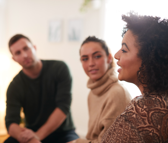 People sitting indoors in a group, talking