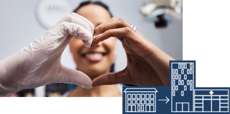 Woman with hands cupped withe shape of a heart alongside a hospital building